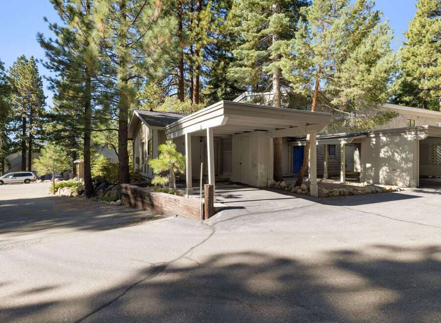 Discover this charming home nestled among mature pine trees, offering a serene and private setting.