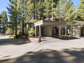 Discover this charming home nestled among mature pine trees, offering a serene and private setting.