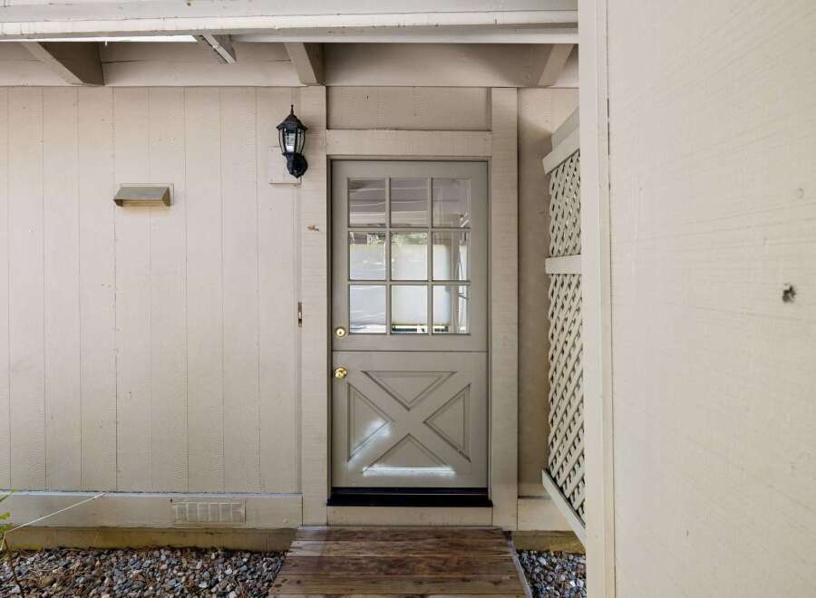 Charming Dutch door entry with a multi-pane glass upper section and a decorative lower panel.