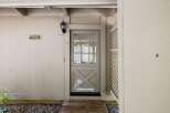 Charming Dutch door entry with a multi-pane glass upper section and a decorative lower panel.