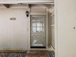 Charming Dutch door entry with a multi-pane glass upper section and a decorative lower panel.