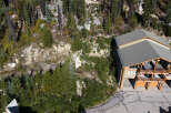 Experience mountain living in this stunning property nestled amongst lush evergreen trees and rocky terrain.