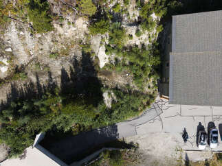 Discover this stunning property featuring a modern building with a durable grey shingle roof, perfect for any climate.