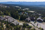 Discover this stunning mountain retreat, nestled amidst a dense evergreen forest with breathtaking panoramic views of distant mountain ranges.