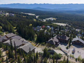 Discover this stunning mountain retreat, nestled amidst a dense evergreen forest with breathtaking panoramic views of distant mountain ranges.