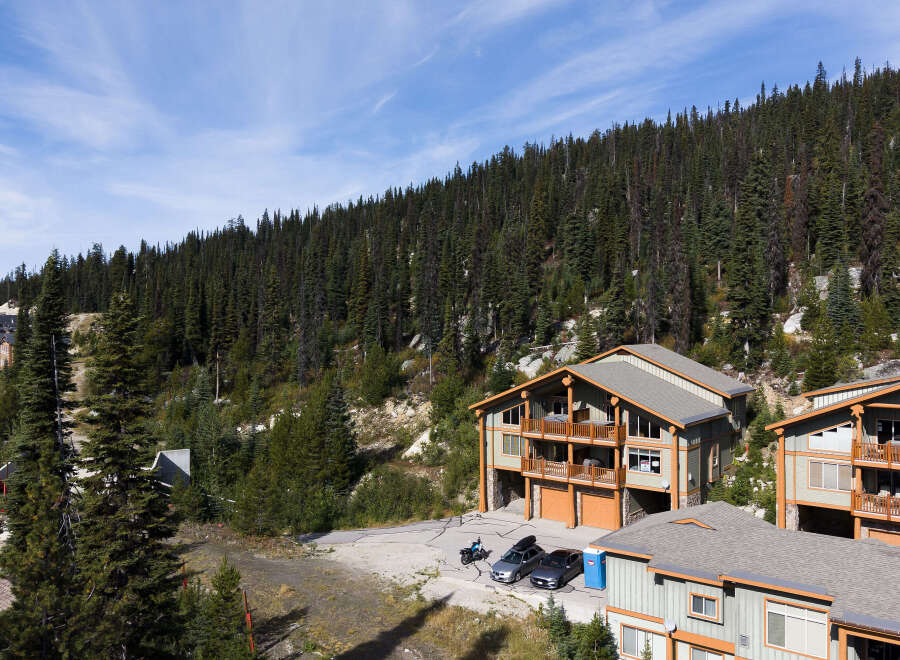 Experience mountain living in this stunning property nestled amidst a dense evergreen forest.
