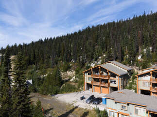 Experience mountain living in this stunning property nestled amidst a dense evergreen forest.