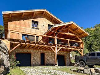 Experience luxury mountain living in this stunning wooden chalet, featuring a multi-level design with expansive balconies perfect for enjoying breathtaking views.