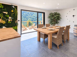 Experience breathtaking mountain views from this stunning dining area, featuring a large sliding glass door that opens to a private deck.