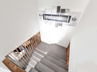Ascend in style with this modern staircase featuring sleek concrete steps and warm wooden railings.