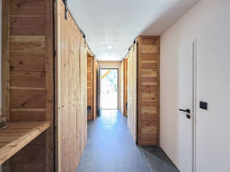 Step into this charming hallway featuring rustic wooden sliding doors that add warmth and character.