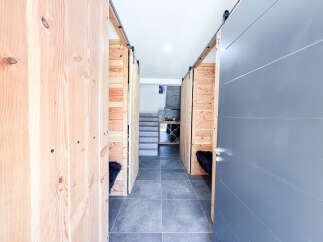 Discover modern living with this stylish interior featuring unique wooden barn doors that open to reveal cozy spaces.