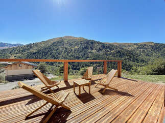 Enjoy breathtaking mountain views from this stunning wooden deck, perfect for relaxation and entertaining.