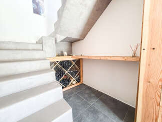 Discover modern living with this unique concrete staircase, leading to a stylish wine cellar integrated beneath.