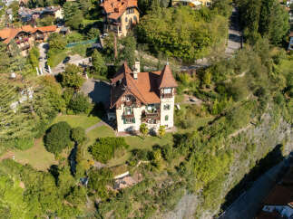 Discover this charming villa nestled amidst lush greenery, offering a serene retreat with stunning architectural details.
