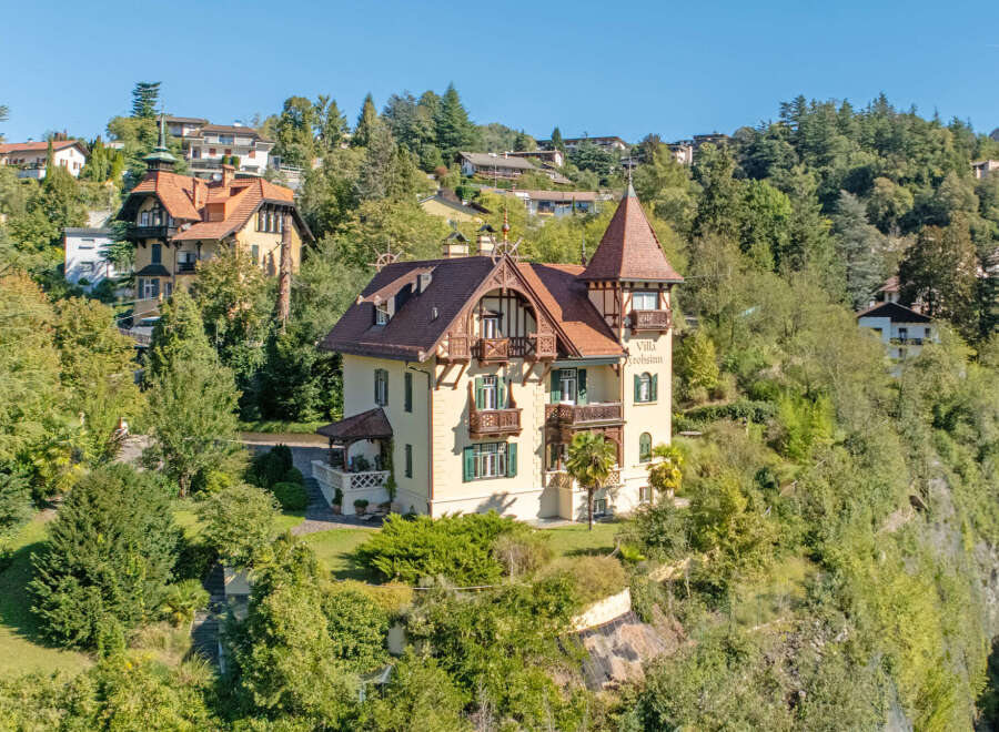 Discover this charming historic villa nestled on a lush hillside, offering breathtaking views and a serene atmosphere.