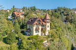 Discover this charming historic villa nestled on a lush hillside, offering breathtaking views and a serene atmosphere.