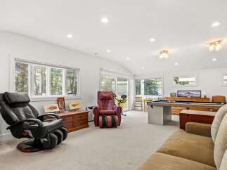 This spacious recreation room offers a perfect blend of relaxation and entertainment.