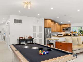 Enjoy endless entertainment in this versatile living space, featuring a professional-grade pool table perfect for friendly competitions.