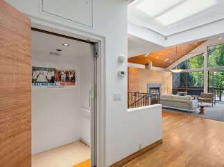 Step into this stunning modern home featuring an elevator for convenient access between floors.