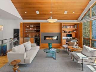 Experience luxury living in this stunning contemporary living room, featuring a sleek gas fireplace as the centerpiece.