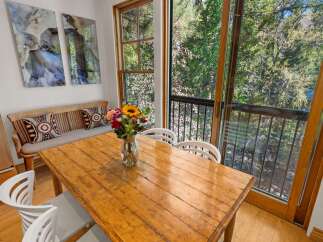 Enjoy a charming dining area with a rustic wooden table, perfect for intimate meals.