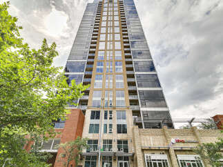 Experience modern urban living in this stunning high-rise apartment building, featuring sleek glass facades and contemporary architectural design.