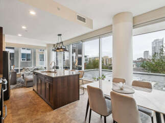 Experience modern urban living in this stunning condo featuring a spacious open-concept layout with a gourmet kitchen island perfect for entertaining.