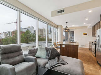 Experience modern city living in this stunning condo featuring expansive floor-to-ceiling windows that flood the space with natural light and offer breathtaking urban views.