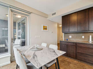 Experience modern living in this stylish dining area, featuring a sleek marble-top dining table and comfortable upholstered chairs.
