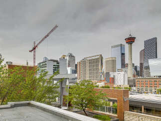 Experience urban living at its finest with this stunning city view, featuring a modern rooftop patio perfect for entertaining.