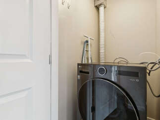 Discover convenience and efficiency in this laundry space, featuring a modern LG WashCombo All-in-One unit.