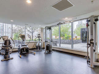 Elevate your fitness routine in this well-equipped gym, featuring a variety of cardio machines and a versatile cable machine.
