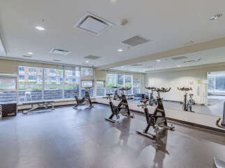 This modern gym features a row of spin bikes, perfect for cardio enthusiasts.