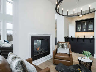 Experience modern luxury in this stunning living space, featuring a cozy gas fireplace as the centerpiece.