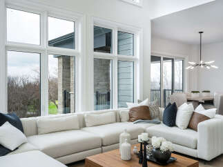 Experience luxurious living in this stunning modern home, featuring a spacious sectional sofa perfect for entertaining.