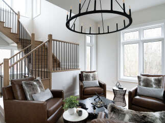 Experience modern luxury in this stunning living space featuring a grand wooden staircase with black railings and a dramatic circular chandelier.