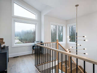 Experience modern living in this stunning home featuring expansive windows that flood the space with natural light.