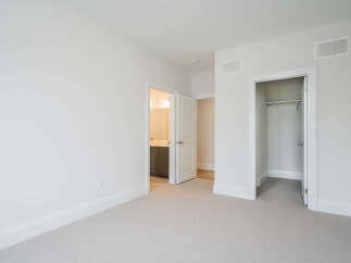 Step into this bright and airy bedroom, featuring a neutral color palette and plush carpeting for ultimate comfort.