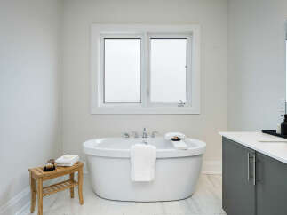 Experience ultimate relaxation in this luxurious bathroom, featuring a freestanding soaking tub perfect for unwinding.