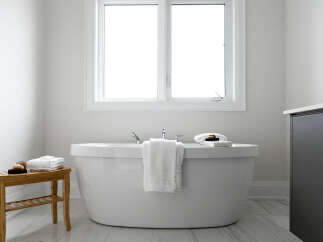 Experience ultimate relaxation in this serene bathroom, featuring a luxurious freestanding bathtub perfect for unwinding.