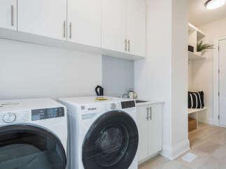 This modern laundry room features a stacked Whirlpool washer and dryer set, perfect for efficient cleaning.