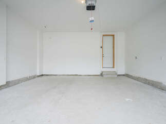 Discover this spacious and clean garage, perfect for your vehicles and storage needs.