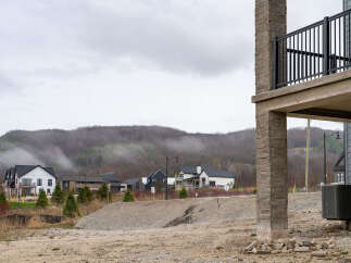 Discover modern living in this new construction development nestled against a misty, tree-covered hillside.
