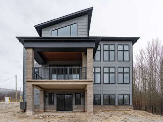 Discover modern living in this stunning multi-level home featuring a striking asymmetrical roofline and expansive windows for abundant natural light.
