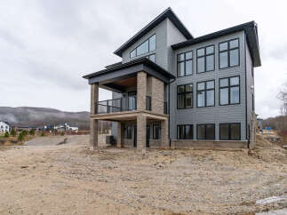 Discover modern luxury in this stunning new construction home, featuring a striking architectural design with expansive windows and a covered balcony.