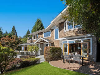 Experience luxurious living in this stunning home, featuring a beautiful cedar shake exterior and expansive windows that invite natural light.