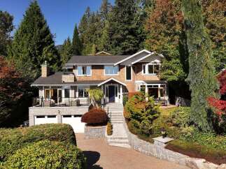 Nestled amidst lush greenery and vibrant autumn foliage, this stunning multi-level home offers a luxurious retreat.