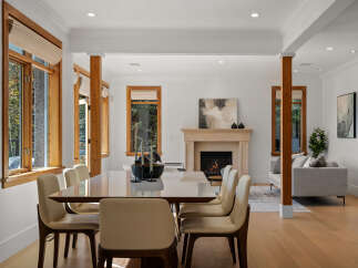 Experience elegant dining and living in this beautifully appointed home, featuring a spacious dining area with a sleek table and chairs, perfect for gatherings.