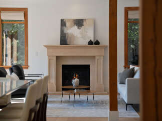 Experience modern living in this beautifully appointed living room, featuring a striking stone fireplace as the focal point.